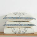 Embroidered pure cotton bed cover with matching quilted pillow shams, folded stack