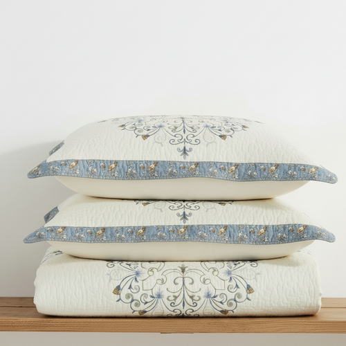 Embroidered pure cotton bed cover with matching quilted pillow shams, folded stack
