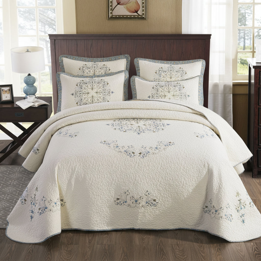European embroidered pure cotton bed cover set styled in a bedroom with matching pillow shams