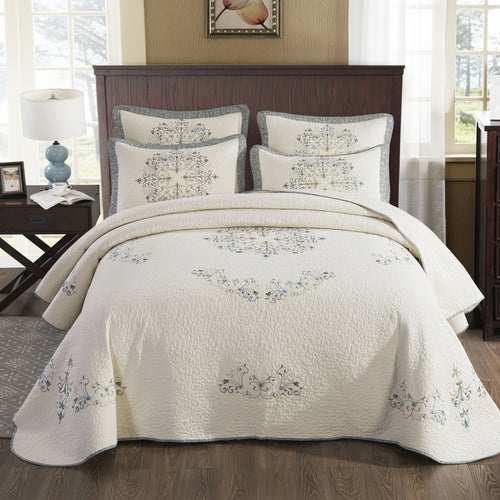 European embroidered pure cotton bed cover set styled in a bedroom with matching pillow shams